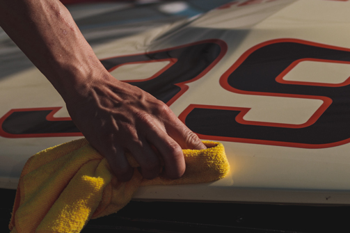 Wiping down a race car hood 